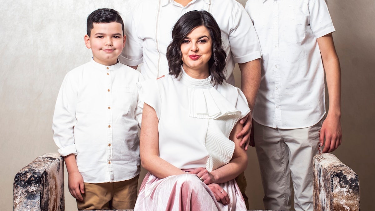 a family posing for a picture in front of a wall